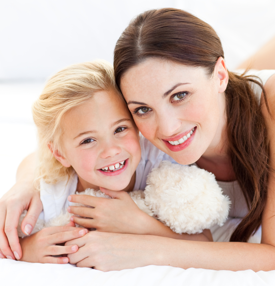 Mother and daughter cuddling before children's dentistry appointment